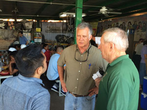 Board Chairs Arshad Hasan and Patrick O'Heffernan speak with the director of the Kino Border Initiative.